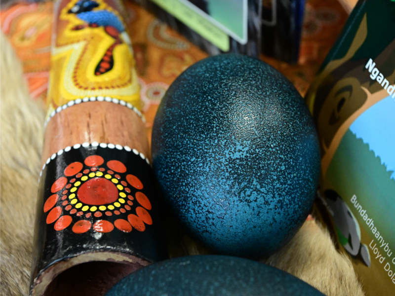 Close up image of didgeridoo and emu egg on a table