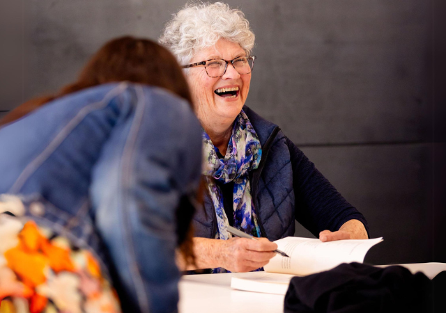 Image of Kate Grenville signing book